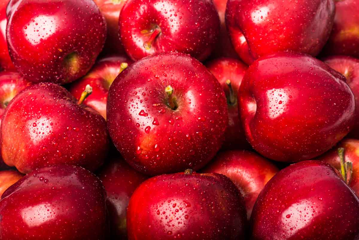 red apples background with water drops